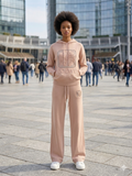 Full-Body Fashion Portrait of a Model in a Dusty Pink Knit Tracksuit at a Public Plaza